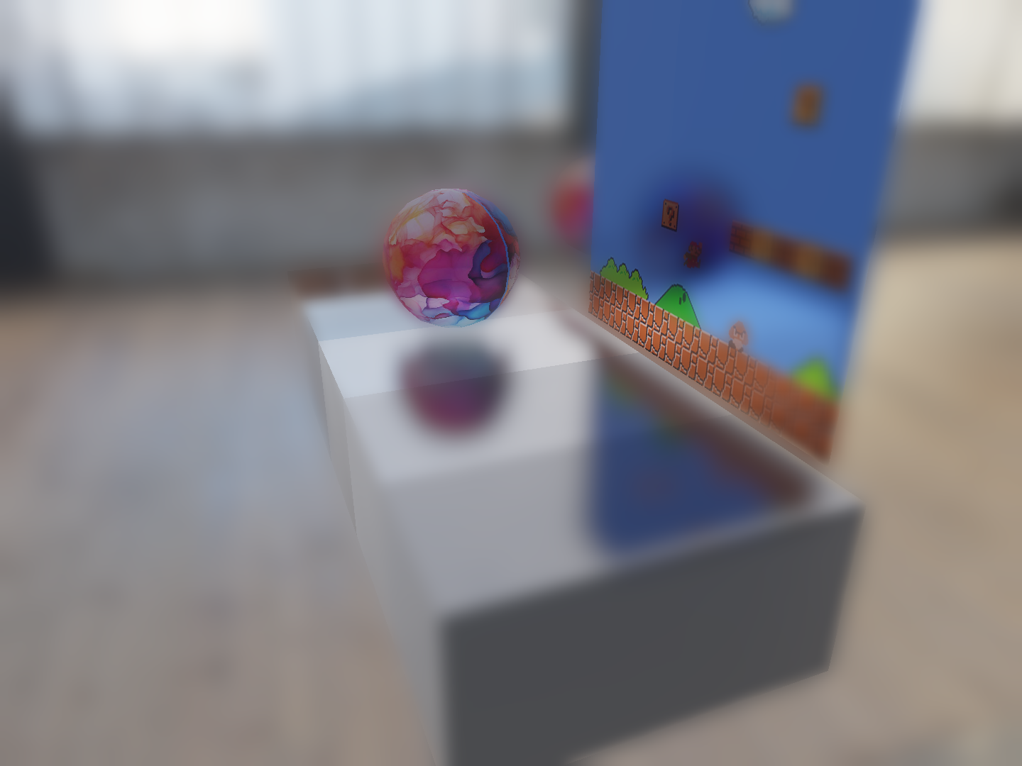 Real-time rendered image showing reflections and depth-of-field blur on spheres and a box with varying roughness